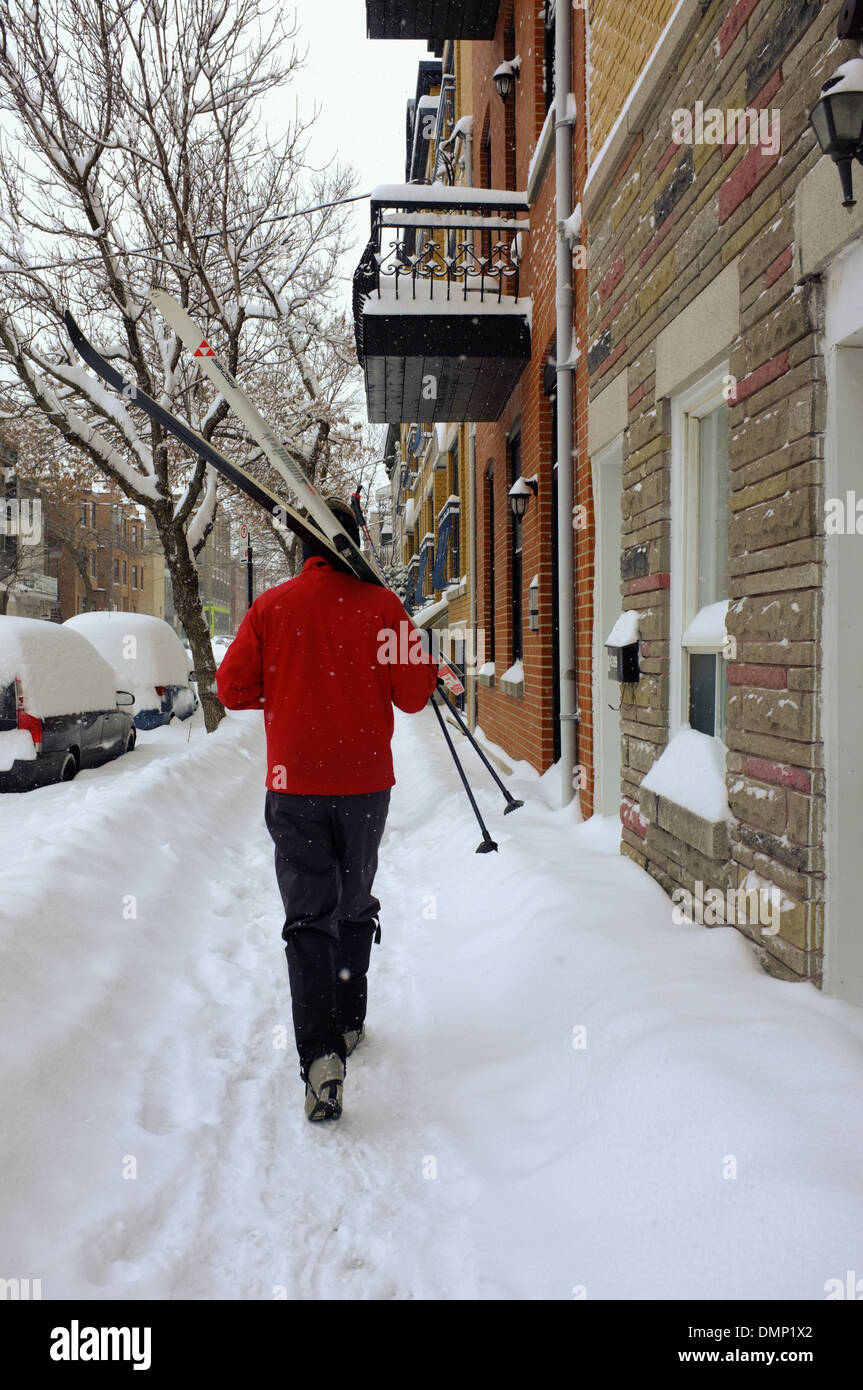 People walking through downtown Montreal with their cross country skis