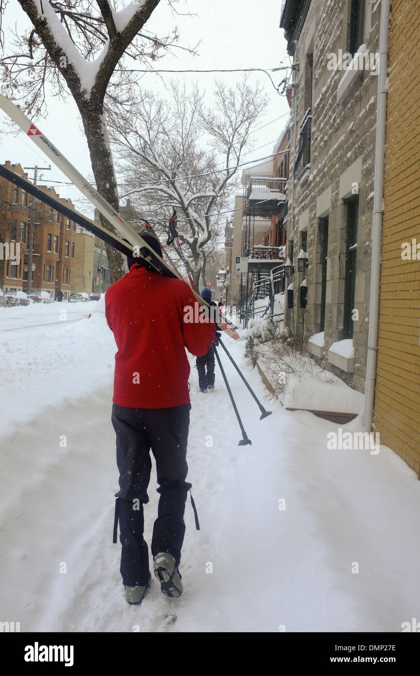 People walking through downtown Montreal with their cross country skis
