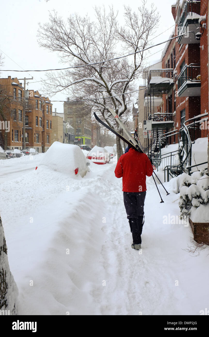 People walking through downtown Montreal with their cross country skis