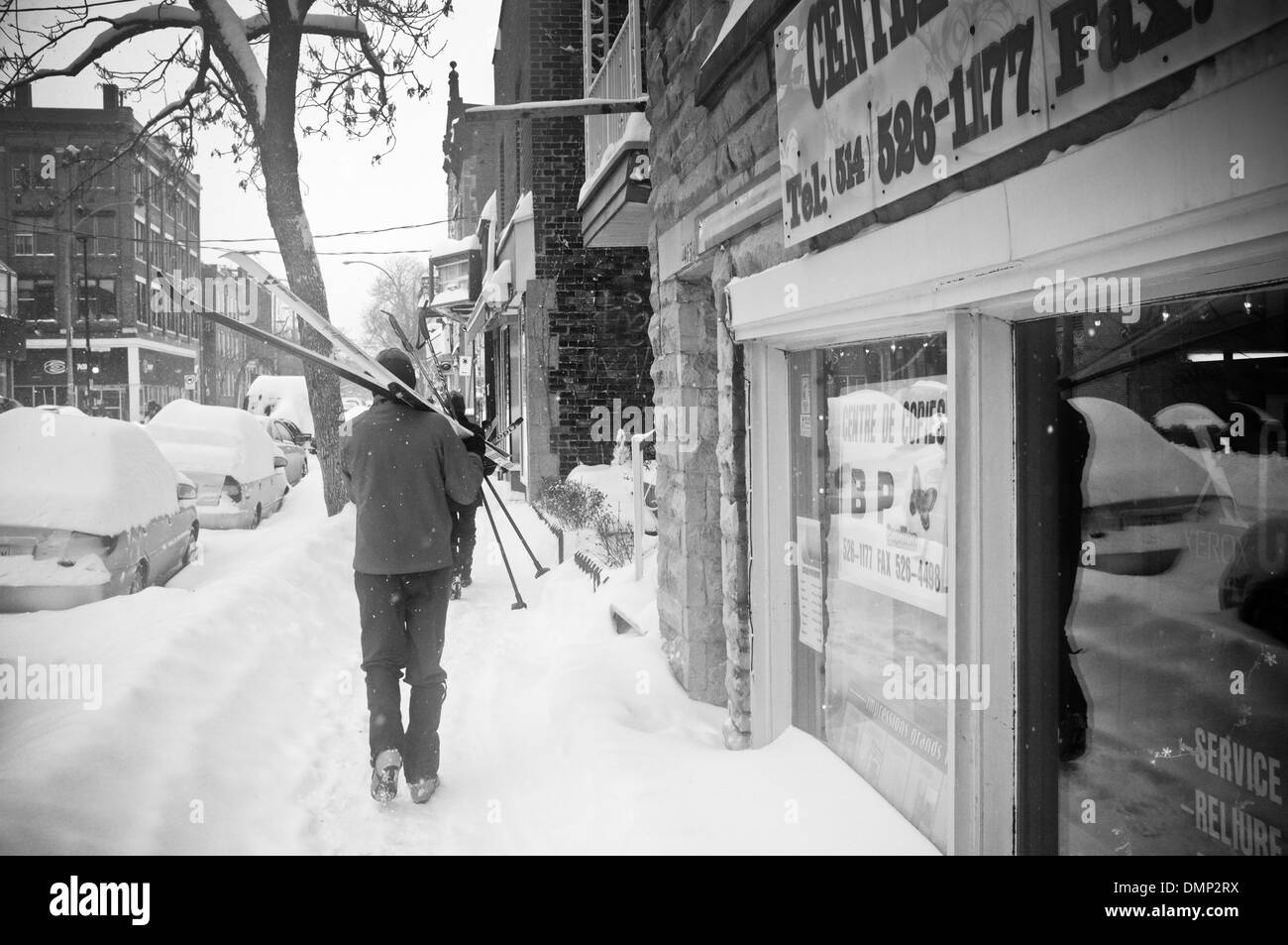 People walking through downtown Montreal with their cross country skis