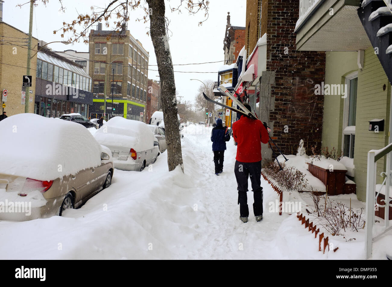 People walking through downtown Montreal with their cross country skis