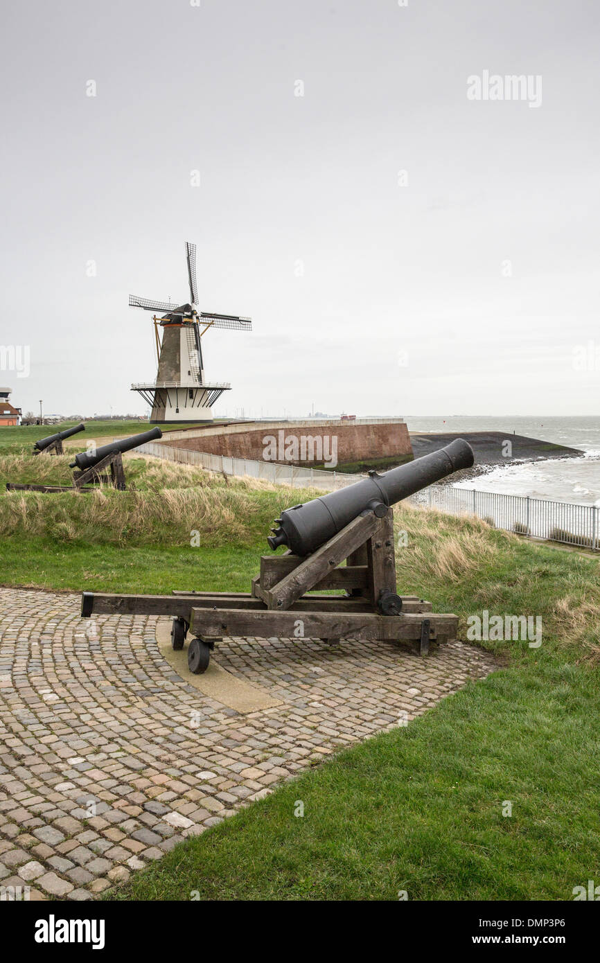 Netherlands, Vlissingen, Canon and windmill on fortification in harbor Stock Photo