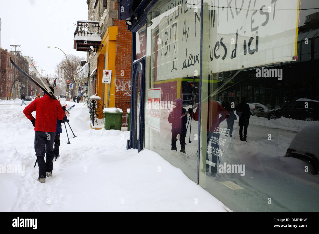 People walking through downtown Montreal with their cross country skis