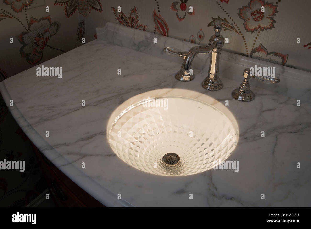 Illuminated Crystal Bathroom Sink With White Marble Counter Stock Photo