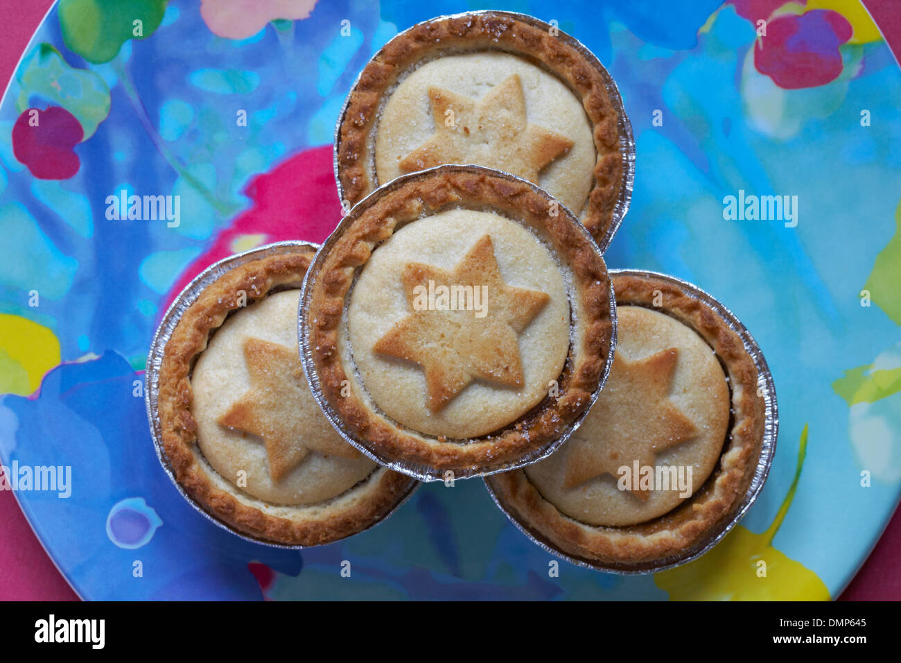 close up of mince pies with stars on, on colourful plate ready for Christmas Stock Photo