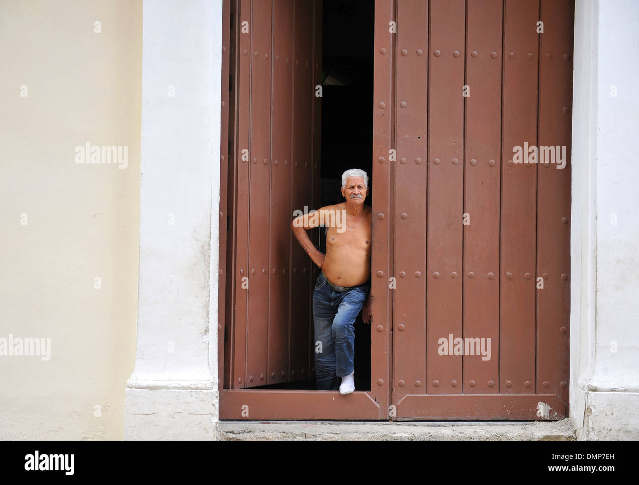 Man looking out onto the street in Havana, Cuba Stock Photo