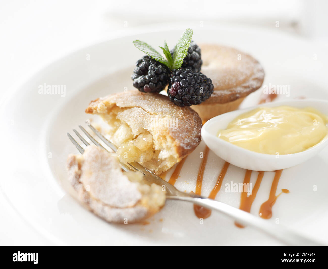 apple pie pies custard blackberries mint sauce dish pot fork napkin Stock Photo