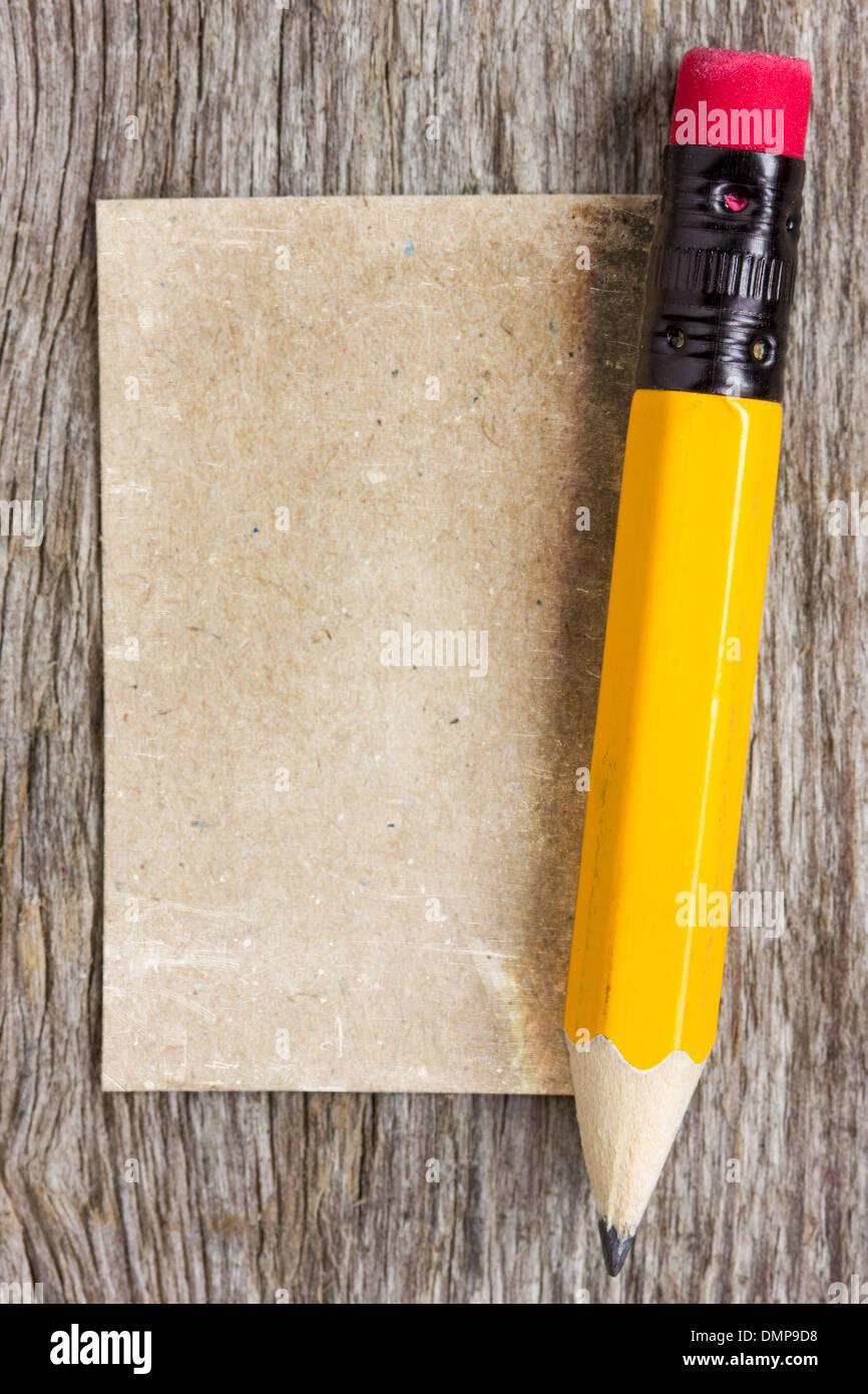 Old paper piece and pencil on a wood background Stock Photo - Alamy