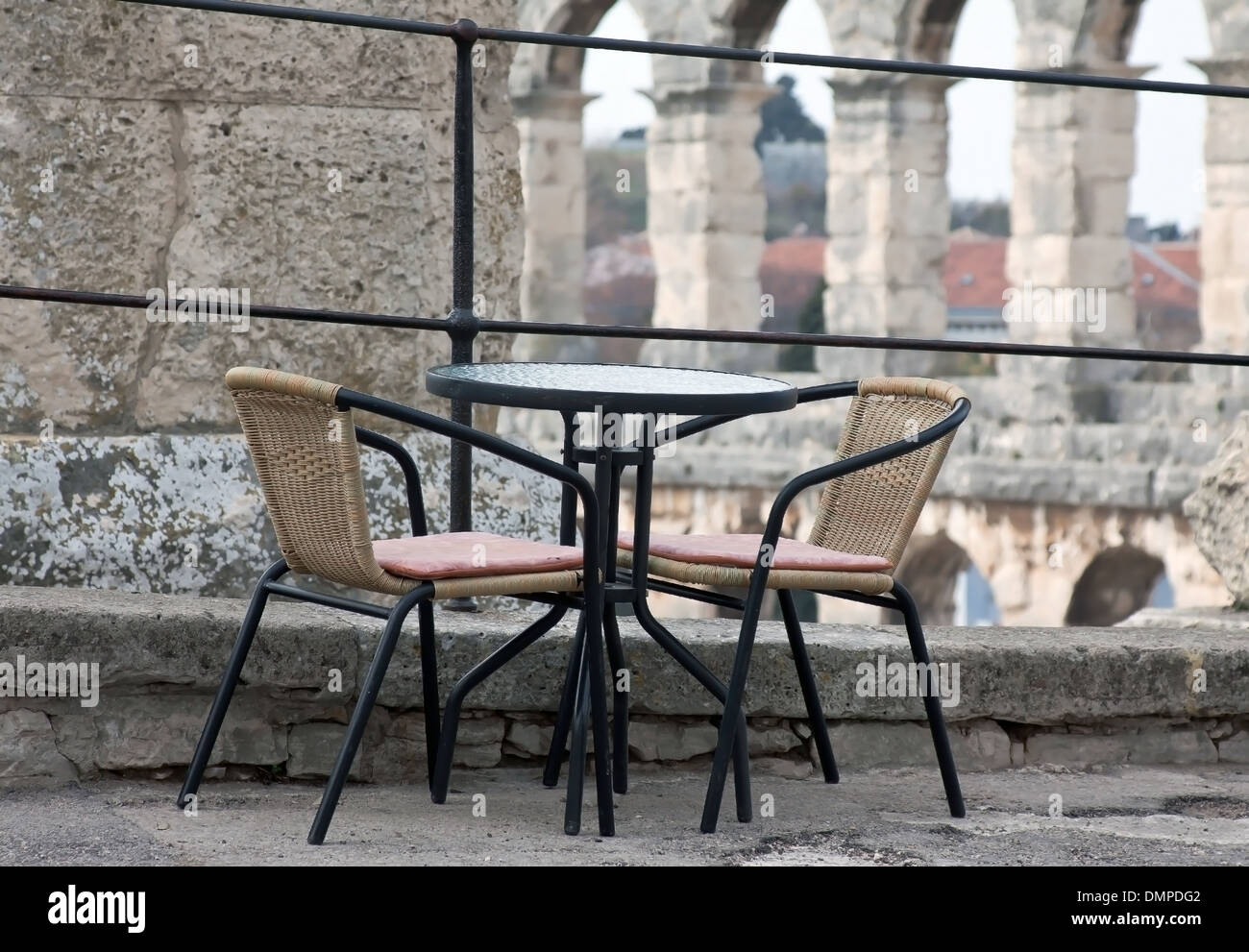table and two chairs outdoor so close to roman amphitheater Stock Photo