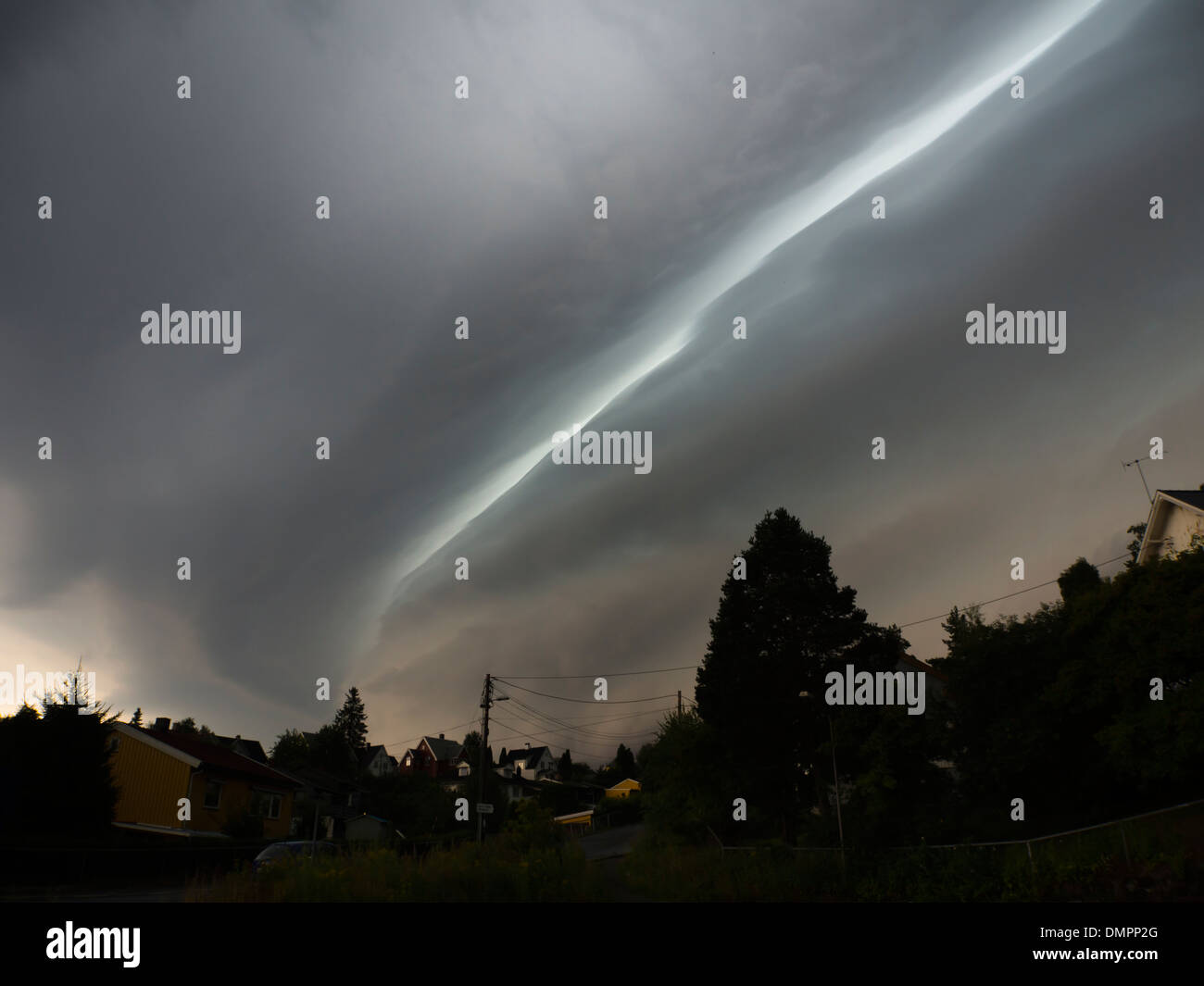 Ominous dark clouds over Oslo Norway, cloud formations with a distinct line of light across the sky, roll cloud or shelf cloud ? Stock Photo