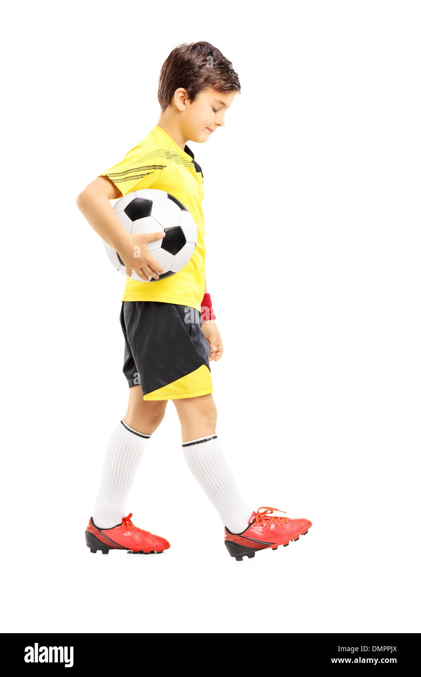 Full length portrait of a sad kid in sportswear posing with a soccer ball Stock Photo