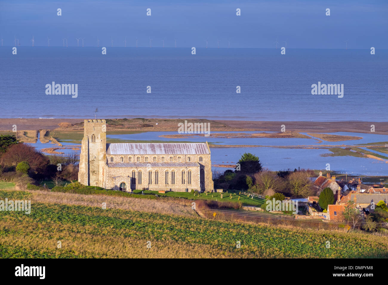 Church of St Nicholas, Salthouse, showing flooded freshmarsh, December 2013. Stock Photo