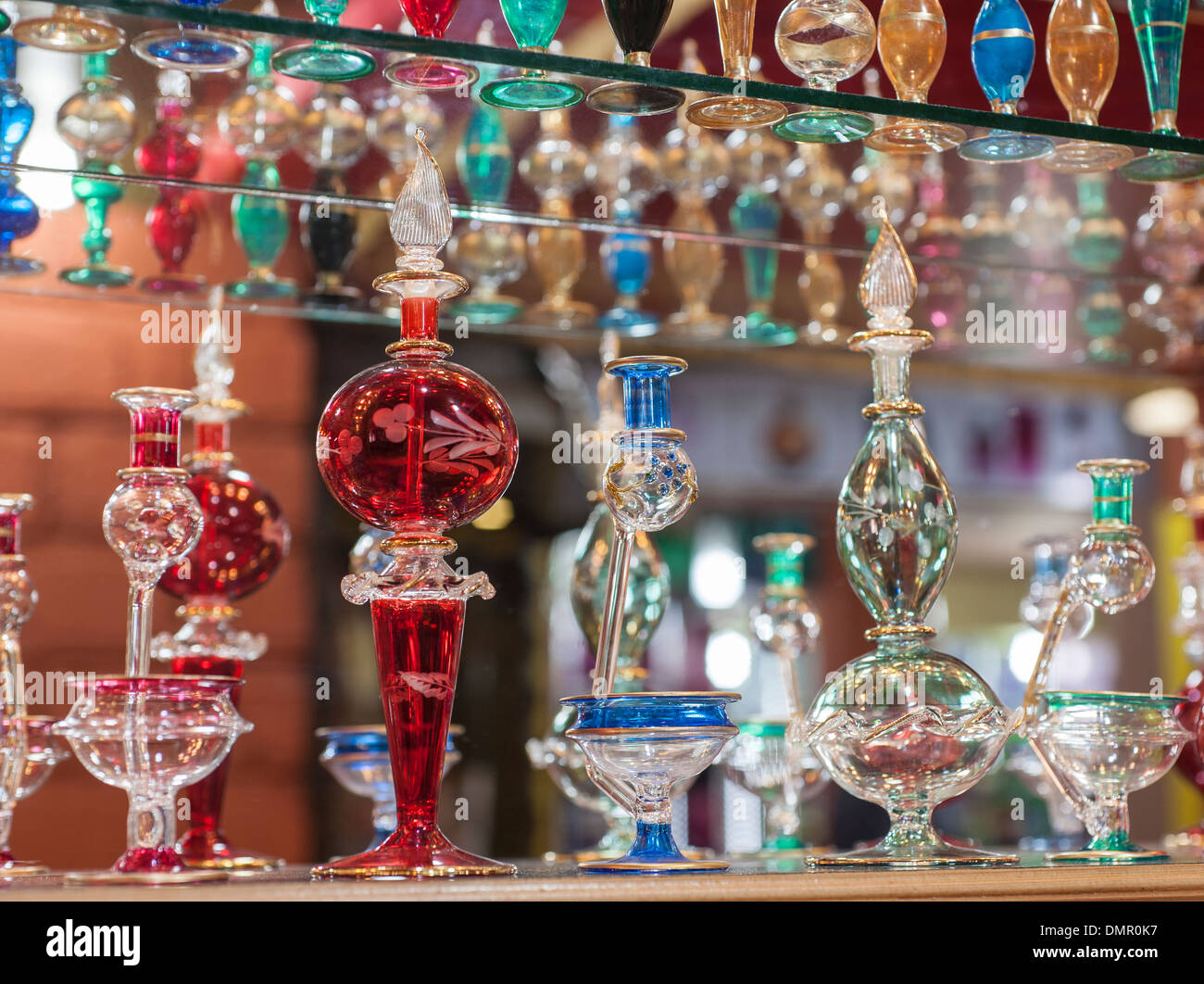 Rows of ornate multicolored perfume bottles on a shelf in egyptian bazaar shop Stock Photo