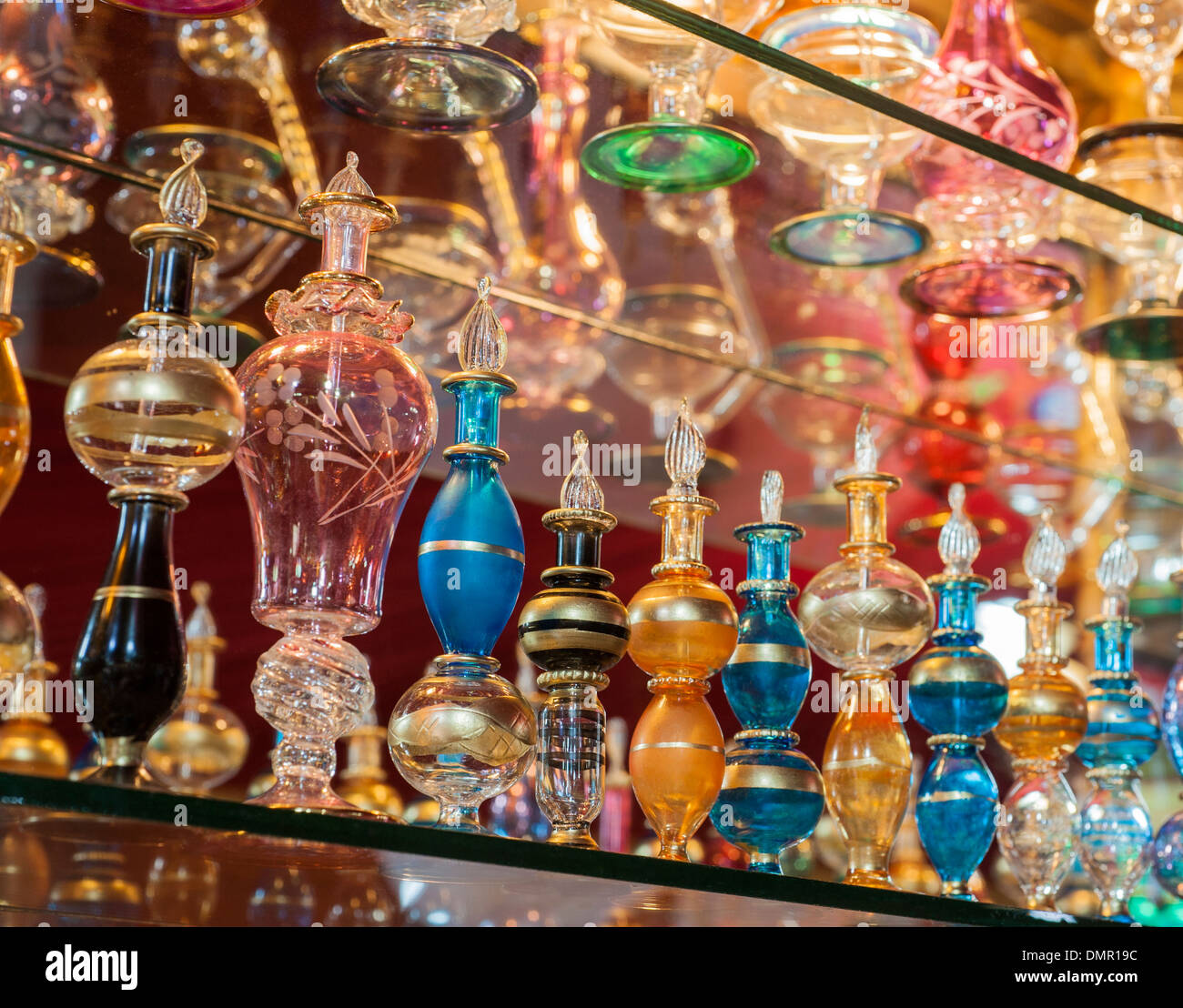 Rows of ornate multicolored perfume bottles on a shelf in egyptian bazaar shop Stock Photo