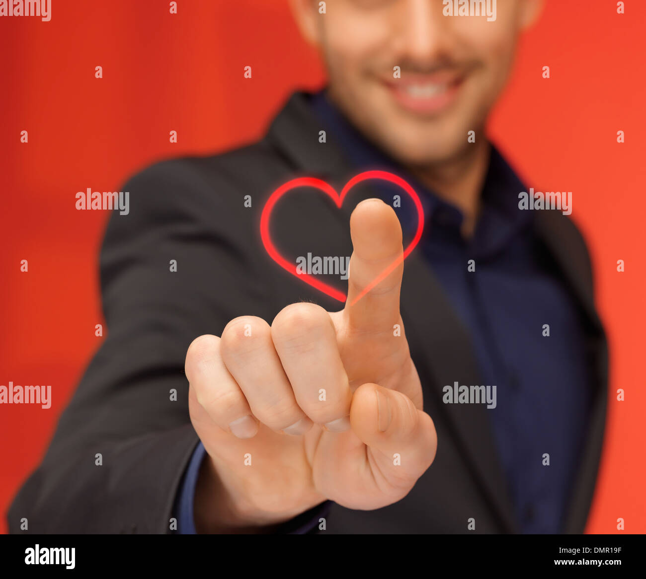 handsome man in suit pressing virtual button Stock Photo