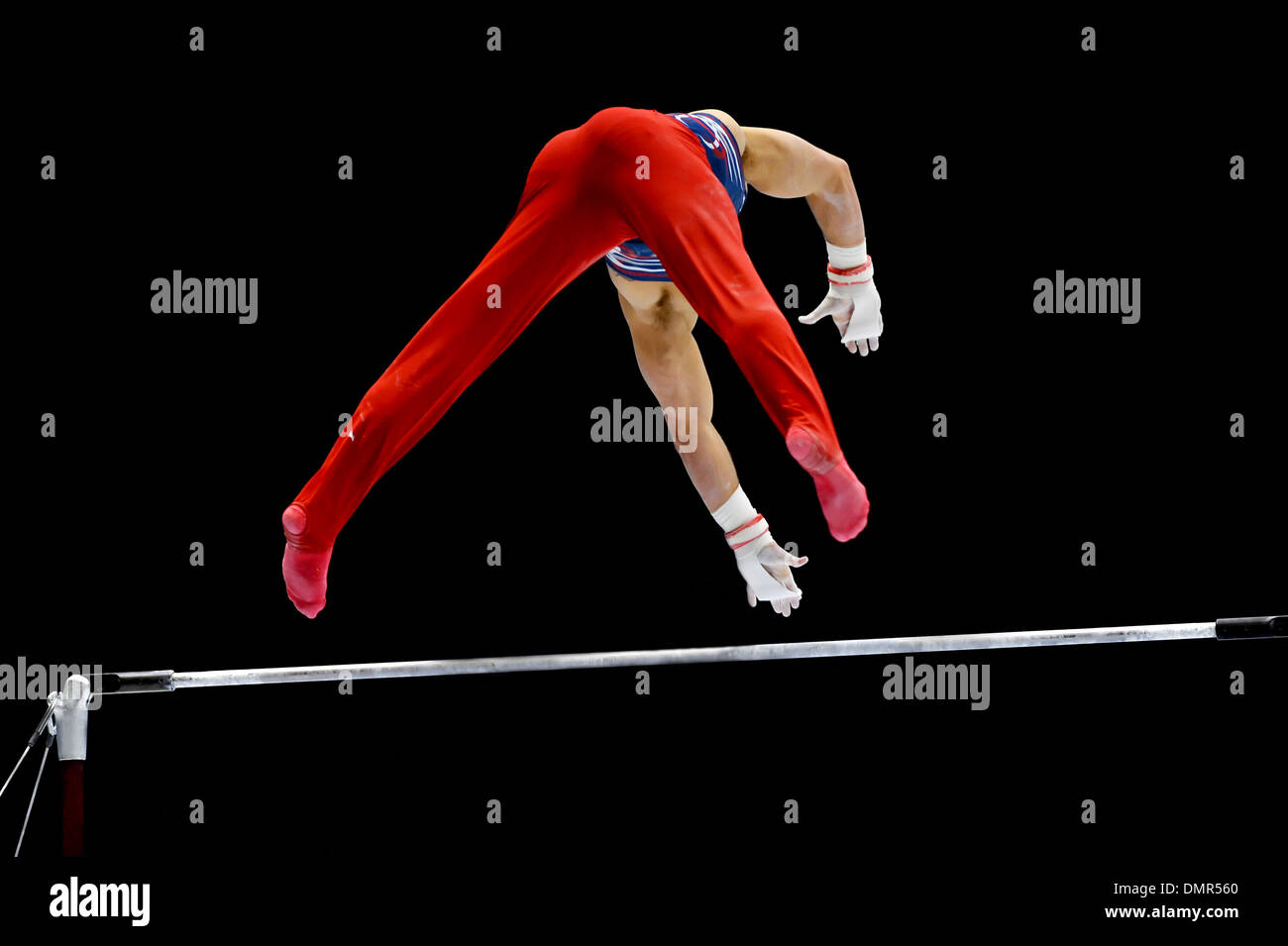 Gymnast performs on the uneven bars apparatus Stock Photo