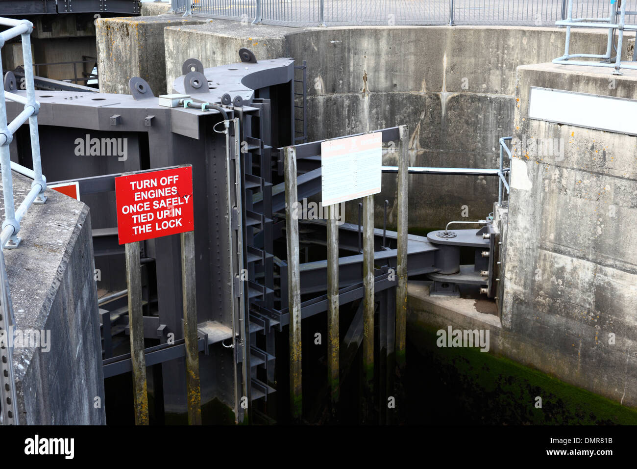 Sign on lock gate telling boat captains to turn off engines once tied up in the lock, Cardiff Bay Barrage , Cardiff, Wales, UK Stock Photo