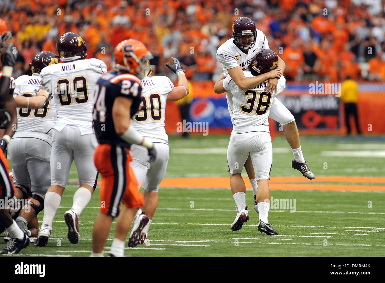 Minnesota Golden Gopher game hero Eric Ellestad gets a boost from teammate  Blake Haudan ,38, after kicking the game winning field goal in overtime to  give Minnesota the 23-20 win over Syracuse