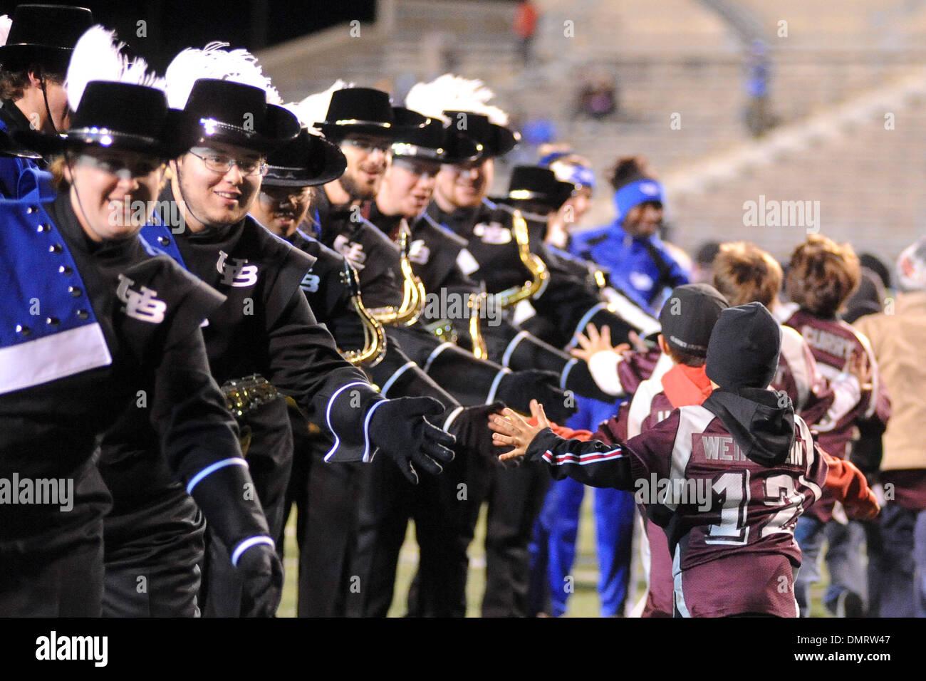 Members of the Buffalo marching band slap hands with some youth
