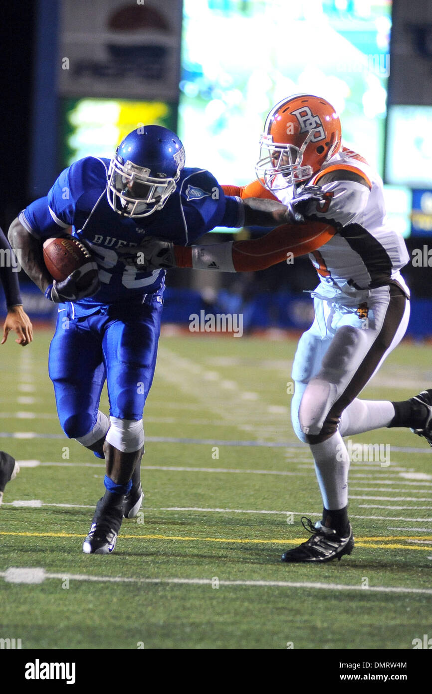 Buffalo Running Back Mario Henry 28 Tries To Break Free From Bowling Green Defensive Back P J Mahone 5 In The Red Zone Buffalo Lost The Game To Bowling Green 30 29 Tuesday Night