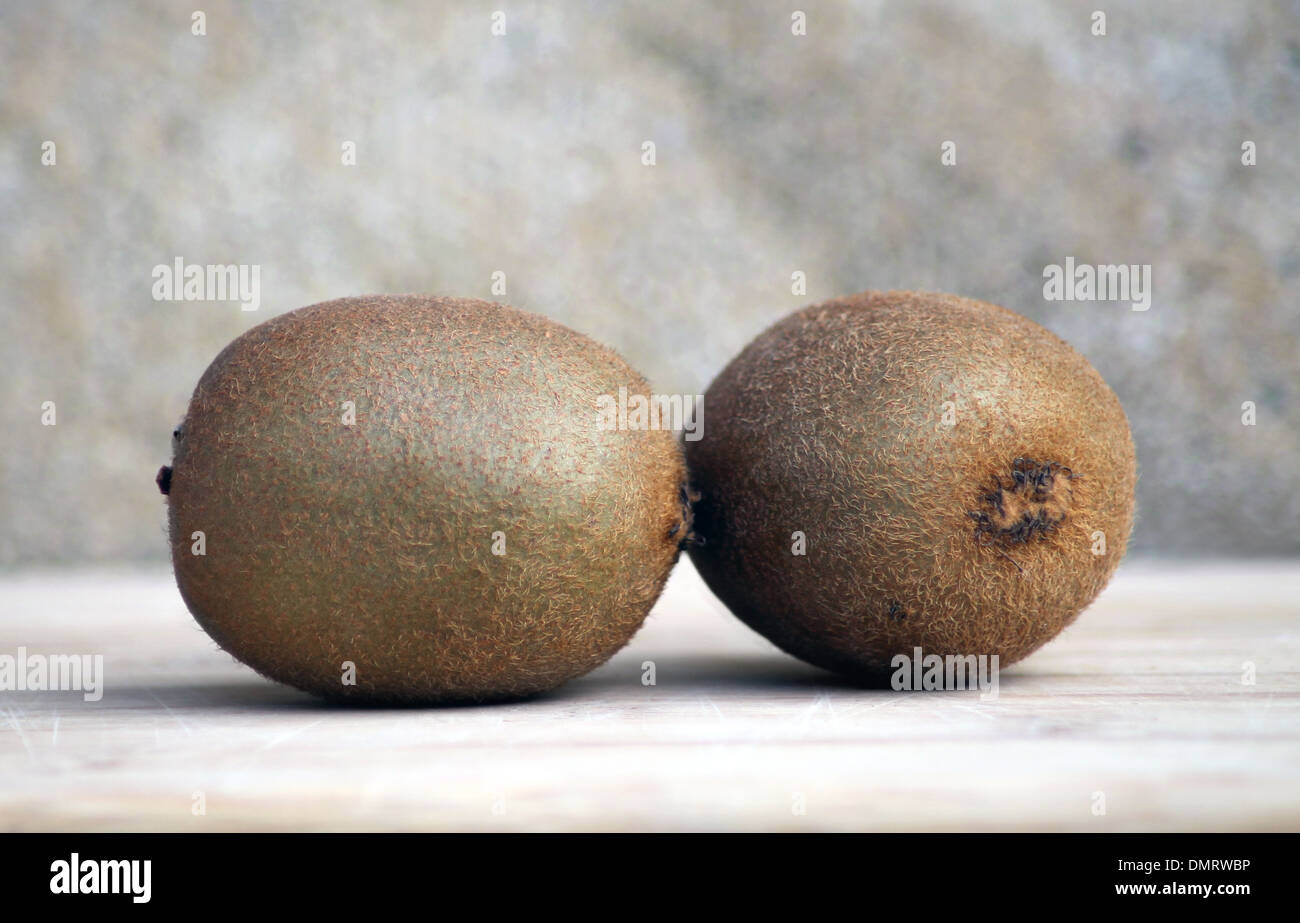 Two ripe kiwi fruit on studio background. Stock Photo