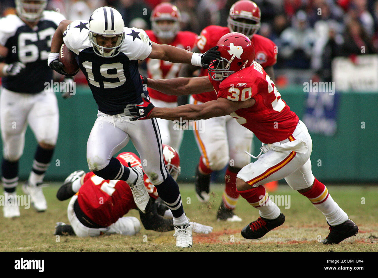 Dallas Cowboys wide receiver Miles Austin (19) stiff arms Kansas City  Chiefs safety Mike Brown (30) during the Cowboy's 26-20 victory over the  Chiefs at Arrowhead Stadium. (Credit Image: © Jacob Paulsen/Southcreek