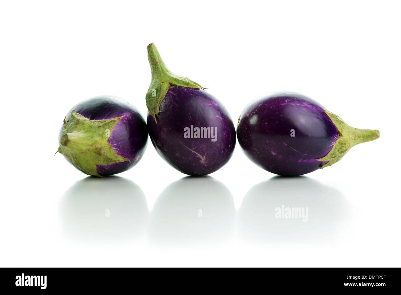 Three eggplants in a row isolated on white background Stock Photo