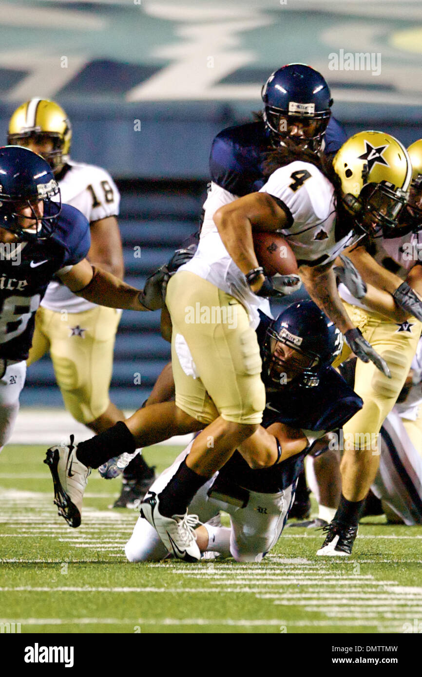 Alex Washington (#4) of the Vanderbilt Commodores is brought down by ...