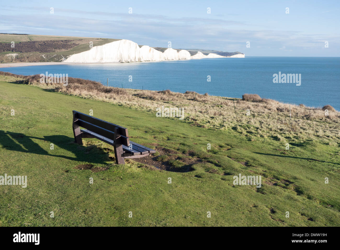 An bench overlooks the chalk cliffs of the Seven Sisters, South Downs National Park, East Sussex, England Stock Photo