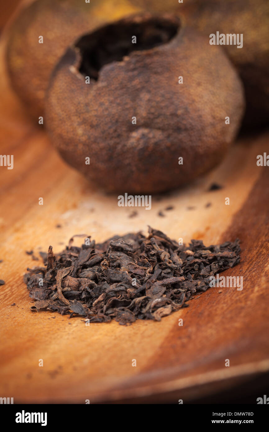 Chinese dark tea Pu-erh on wooden table Stock Photo