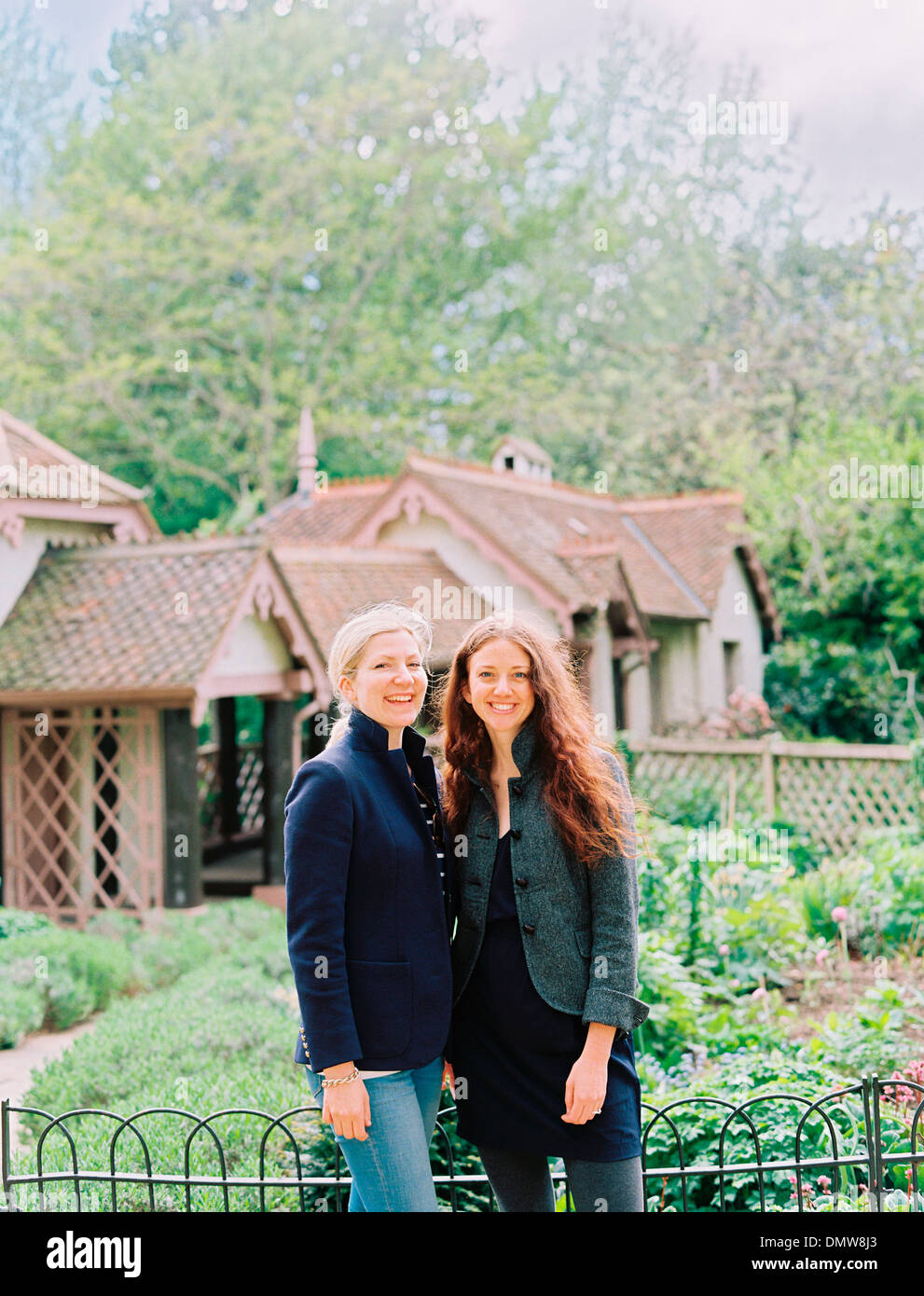 Two women  in a garden of a historic house. Stock Photo