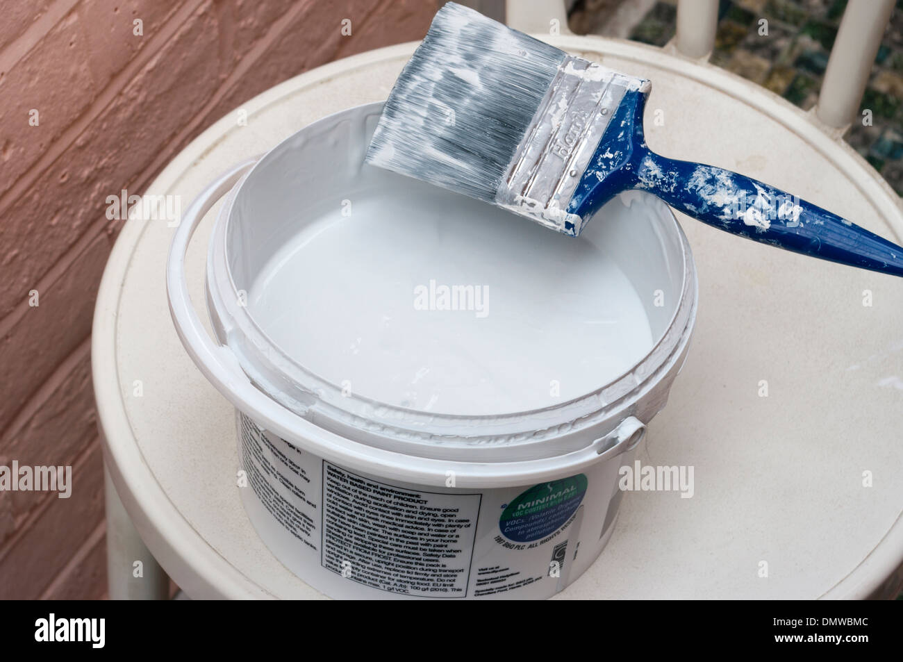 Open Pot Of White Paint and a Paint Brush Stock Photo