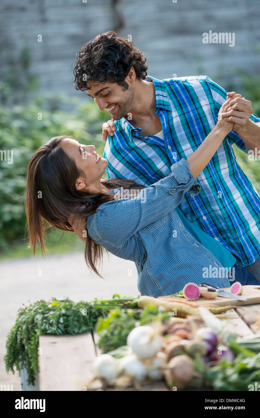 A couple embracing and dancing in a garden. Stock Photo