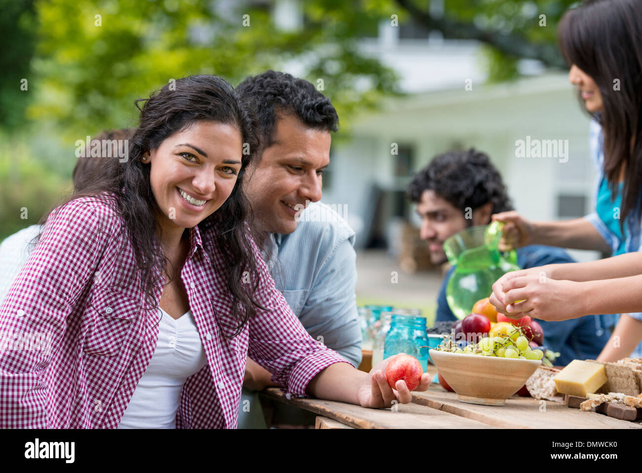 A summer party outdoors. Friends around a table. Stock Photo
