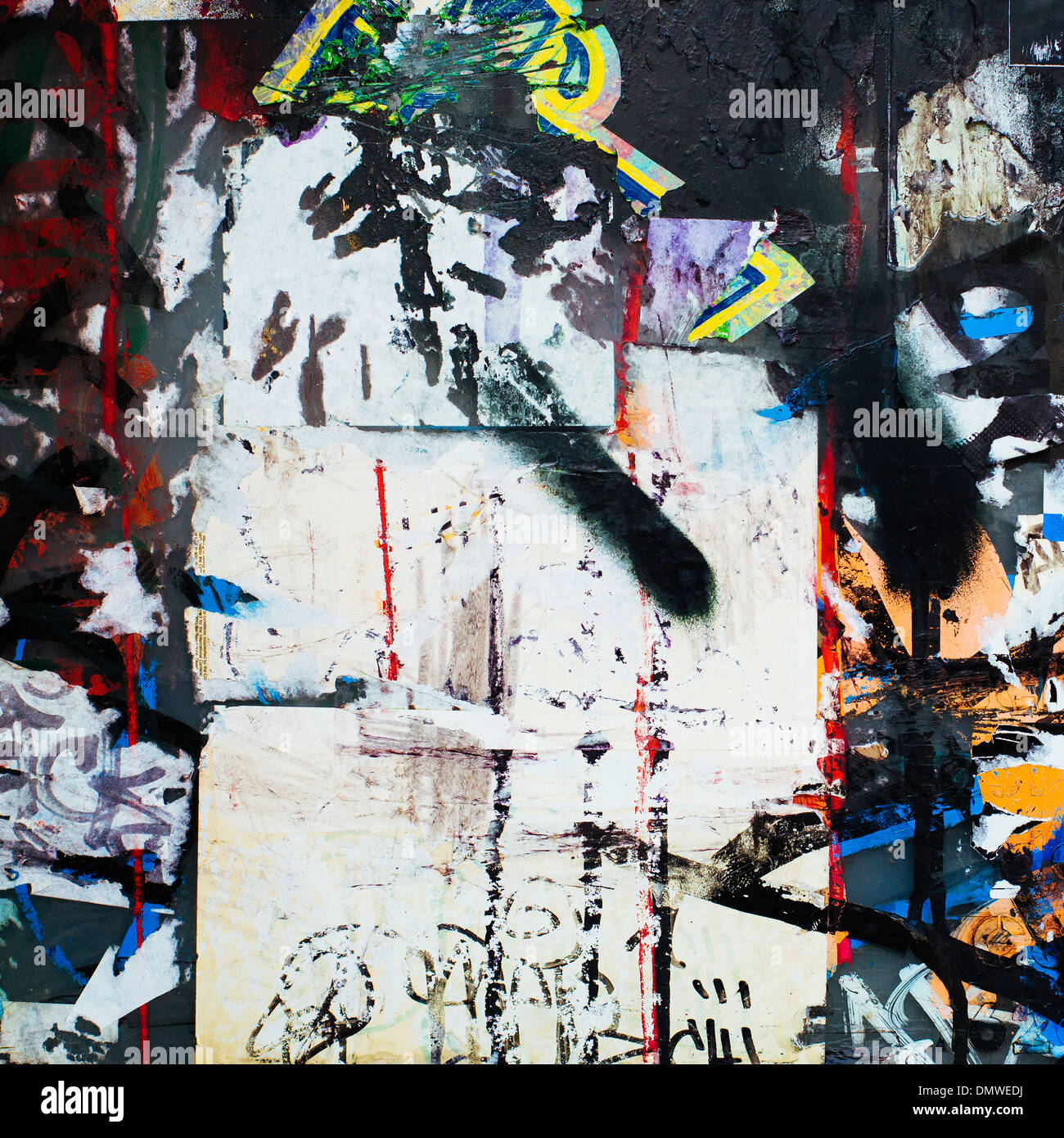 A graffiti covered wall in a city. Streaks of paint drips and