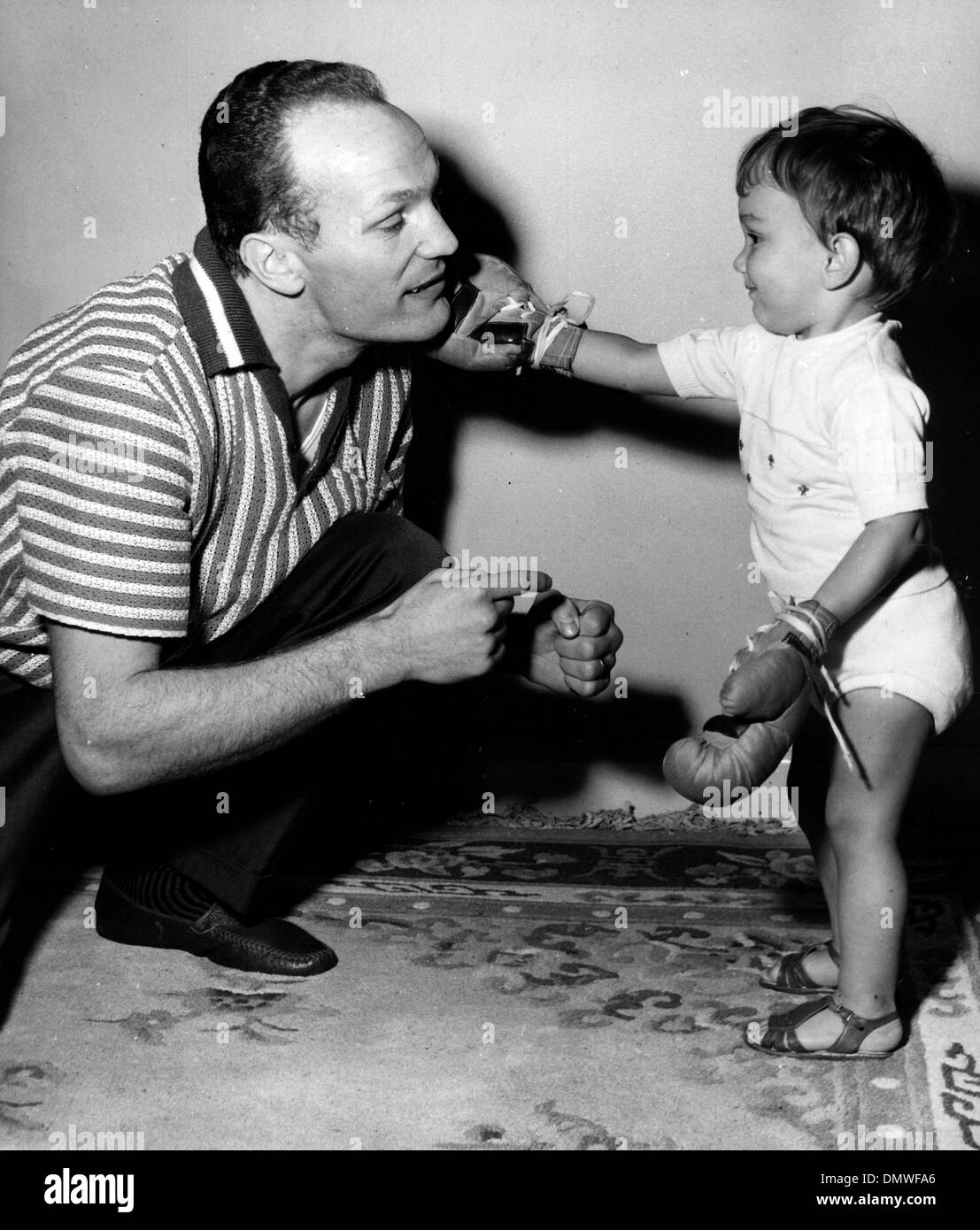 Mar. 27, 1963 - London, England, U.K. - English boxer HENRY COOPER is a champion heavyweight fighter and the only British boxer to win three Lonsdale Belts. PICTURED: Cooper at home with his son HENRY COOPER JR.  (Credit Image: © KEYSTONE Pictures USA/ZUMAPRESS.com) Stock Photo