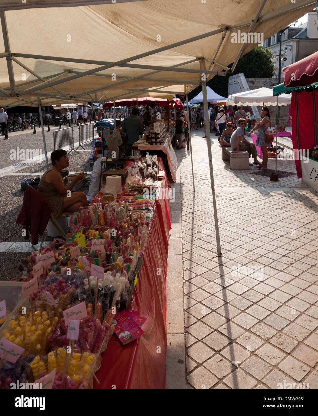 Amboise summer evening market, candy stall with lollypops in celophane