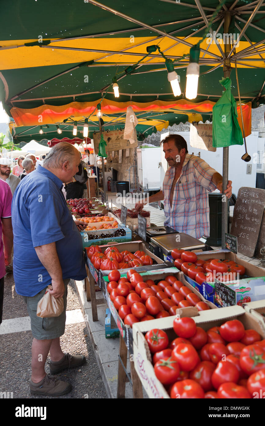 Amboise summer evening market, veg stall with red tomatoes on display