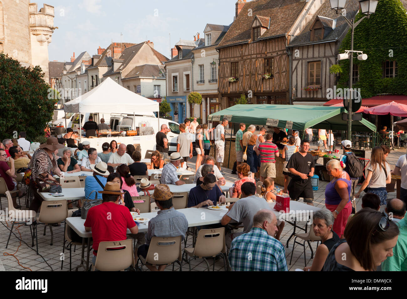 Amboise summer evening market, people sitting down to eat street food from the many stalls Stock Photo