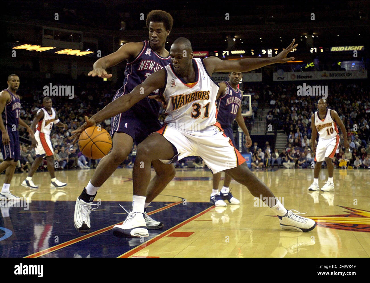 New Jersey Nets General Manager Kiki Vandeweghe (L) watches warm ups as his  son, Ernest Maurice IV, dribbles a basketball before the Nets play the  Denver Nuggets at the Pepsi Center in