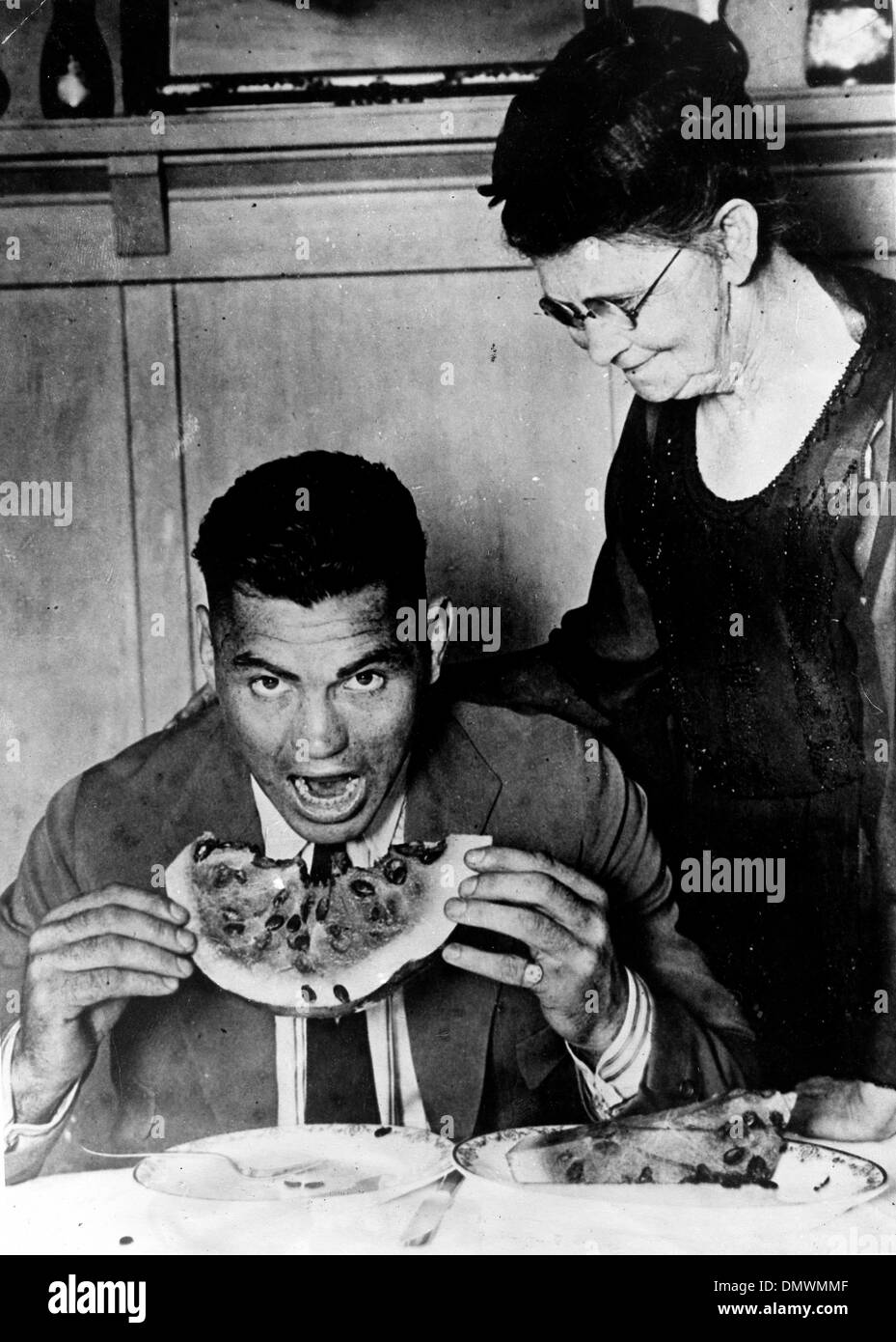 Aug. 5, 1945 - Manassa, CO, U.S. - JACK DEMPSEY with mother eating watermelon. Jack 'Manassa Mauler' Dempsey (June 24, 1895 - May 31, 1983) was an American boxer who held the world heavyweight title from 1919 to 1926. Dempsey's aggressive style and punching power made him one of the most popular boxers in history. Many of his fights set financial and attendance records. (Credit Ima Stock Photo