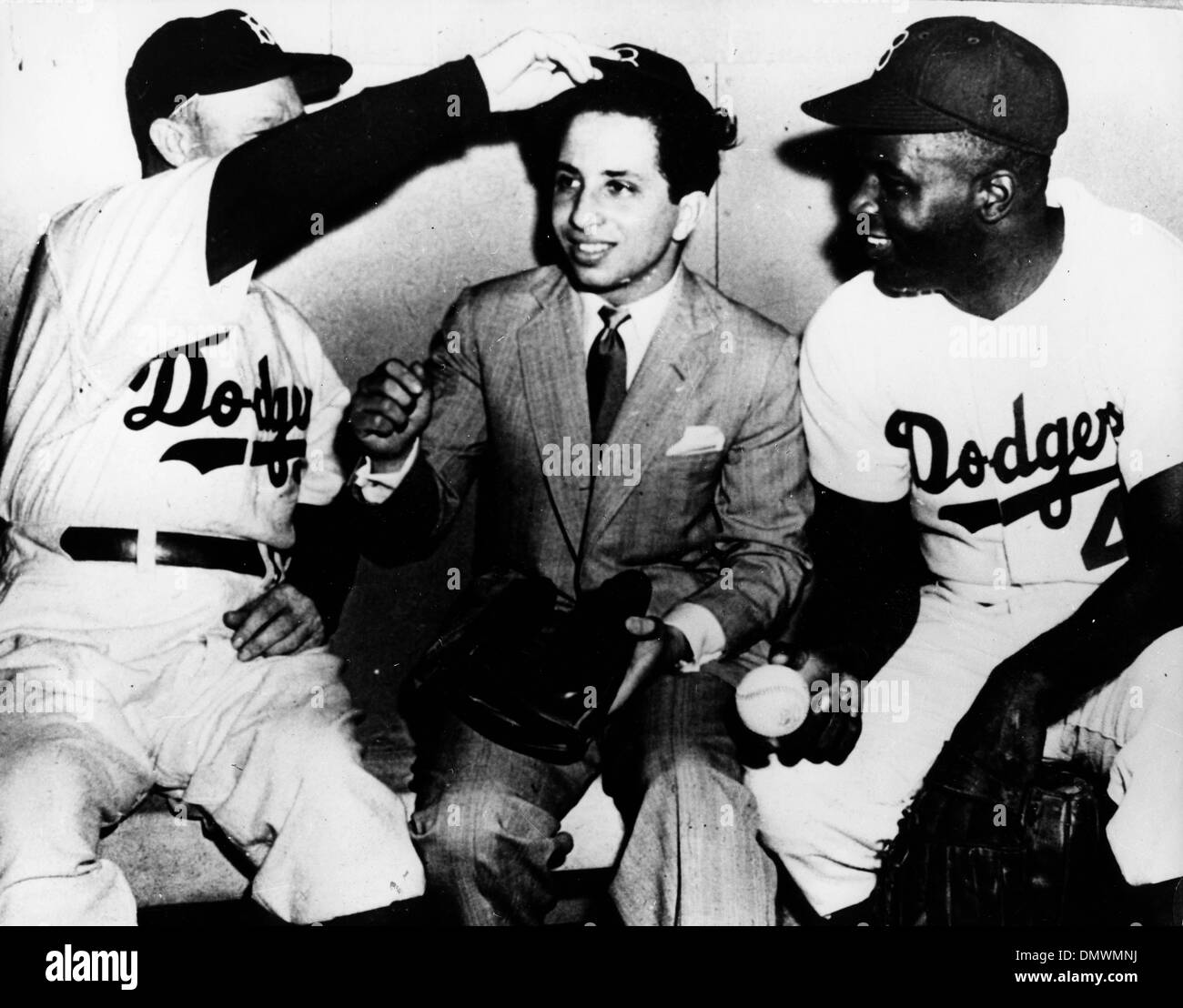 Aug. 18, 1952 - New York, NY, U.S. - King FAISAL II of Iraq attends a baseball game and is welcomed into the dugout. PICTURED: Faisal with Dodgers players JACKIE ROBINSON and manager CHARLES DRESSEN.  (Credit Image: © KEYSTONE Pictures USA/ZUMAPRESS.com) Stock Photo
