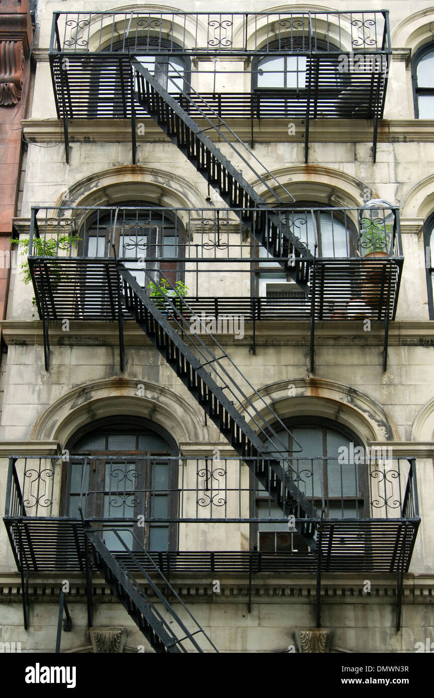 Iron fire escape stairs and balconies on the facade of a building in