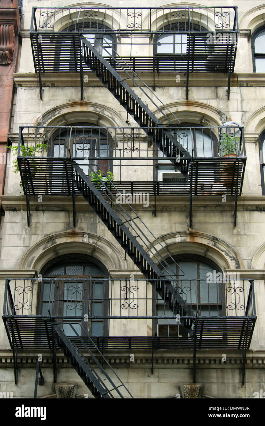 Iron fire escape stairs and balconies on the facade of a building in Soho RE of New York City Stock Photo