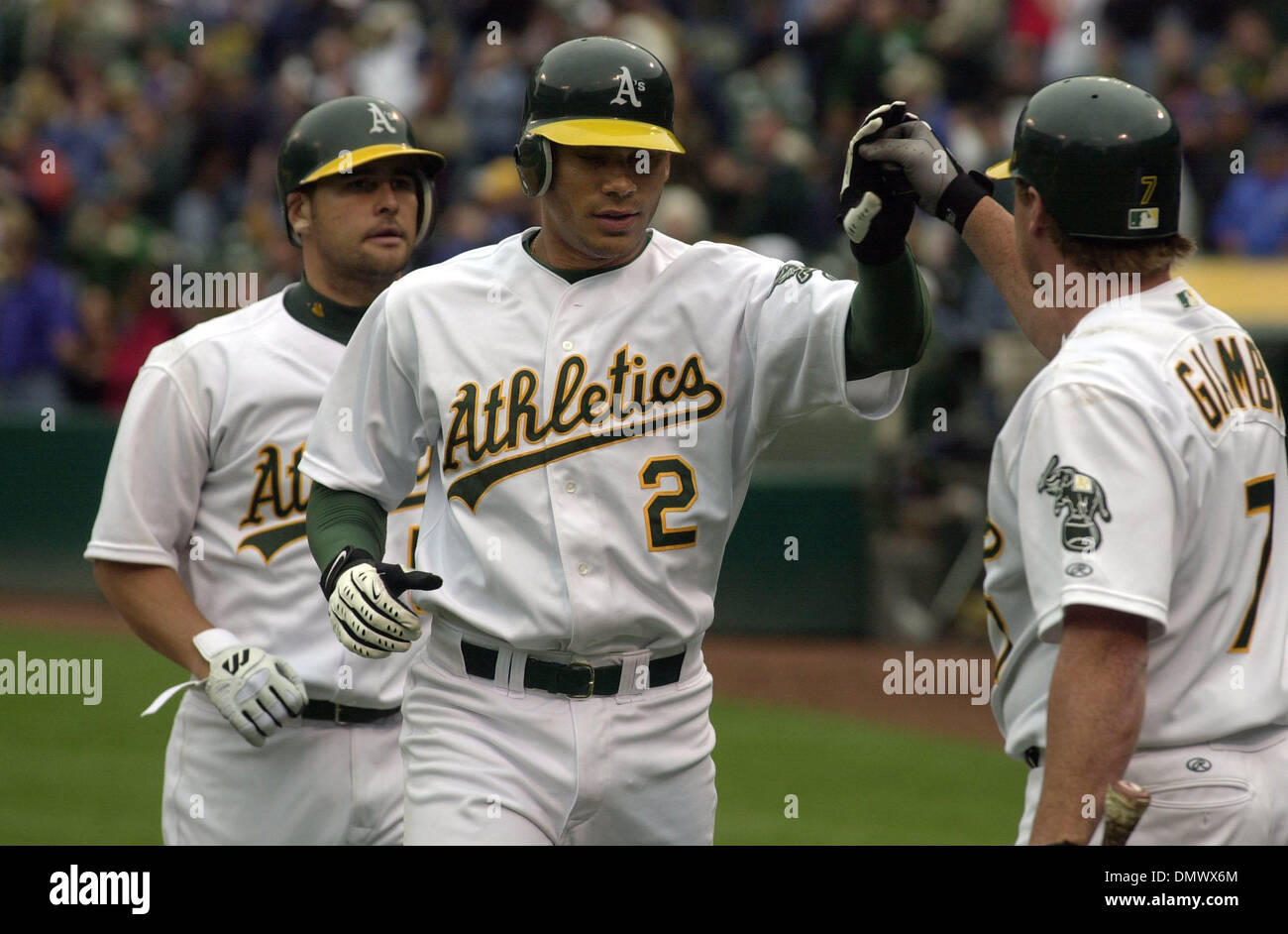 Apr 04, 2002; Oakland, CA, USA; A's Carlos Pena #2 is congratulated at home by next at bat Jeremy Giambi, right,  after Pena hit a 3 run home run in the 9th inning bringing home Olmedo Saenz and Ramon Hernandez making the score 5-7 at Networks Associate Colisium in Oakland, Calif. Thursday April 4, 2002. The Rangers beat the A's 7-5 with the Rangers scoring 5 runs in the sixth inni Stock Photo