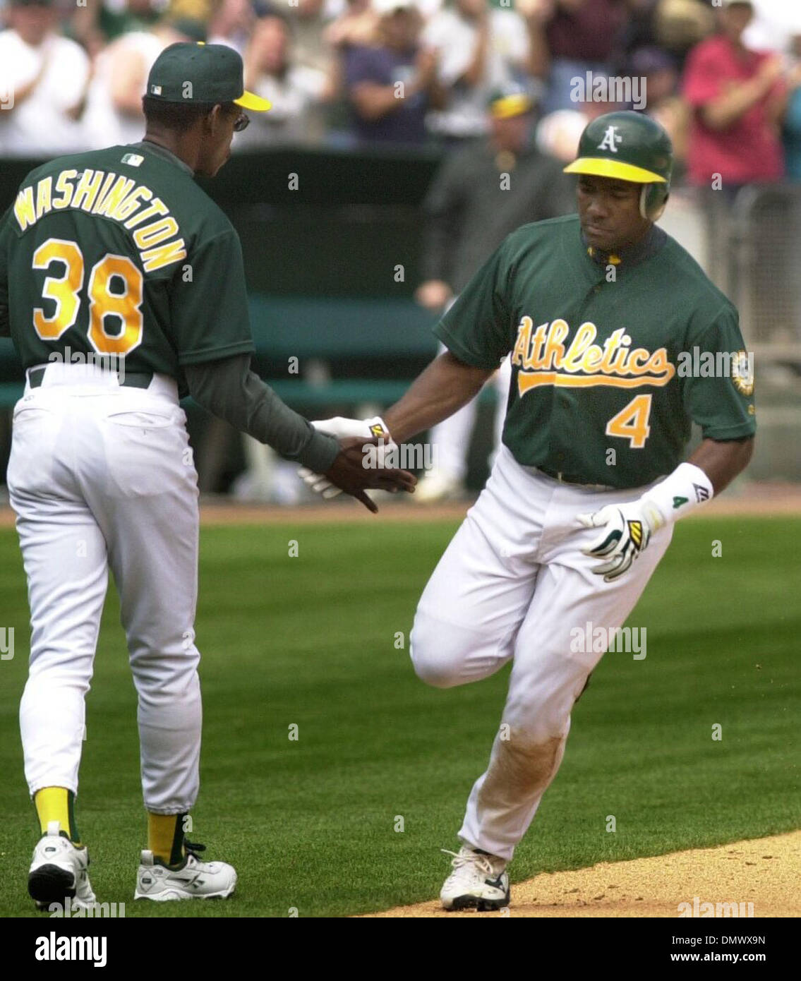 Apr 25, 2002; Oakland, CA, USA; A's thirdbase coach Ron Washington (left) congratulates A's 4