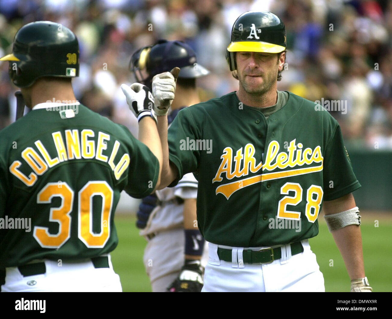 Apr 25, 2002; Oakland, CA, USA; A's #30 Mike Colangelo (right) celebrates  with teammate #28 Greg Myers (right) after Myers hit a homerun in the 6th  inning of their baseball game against