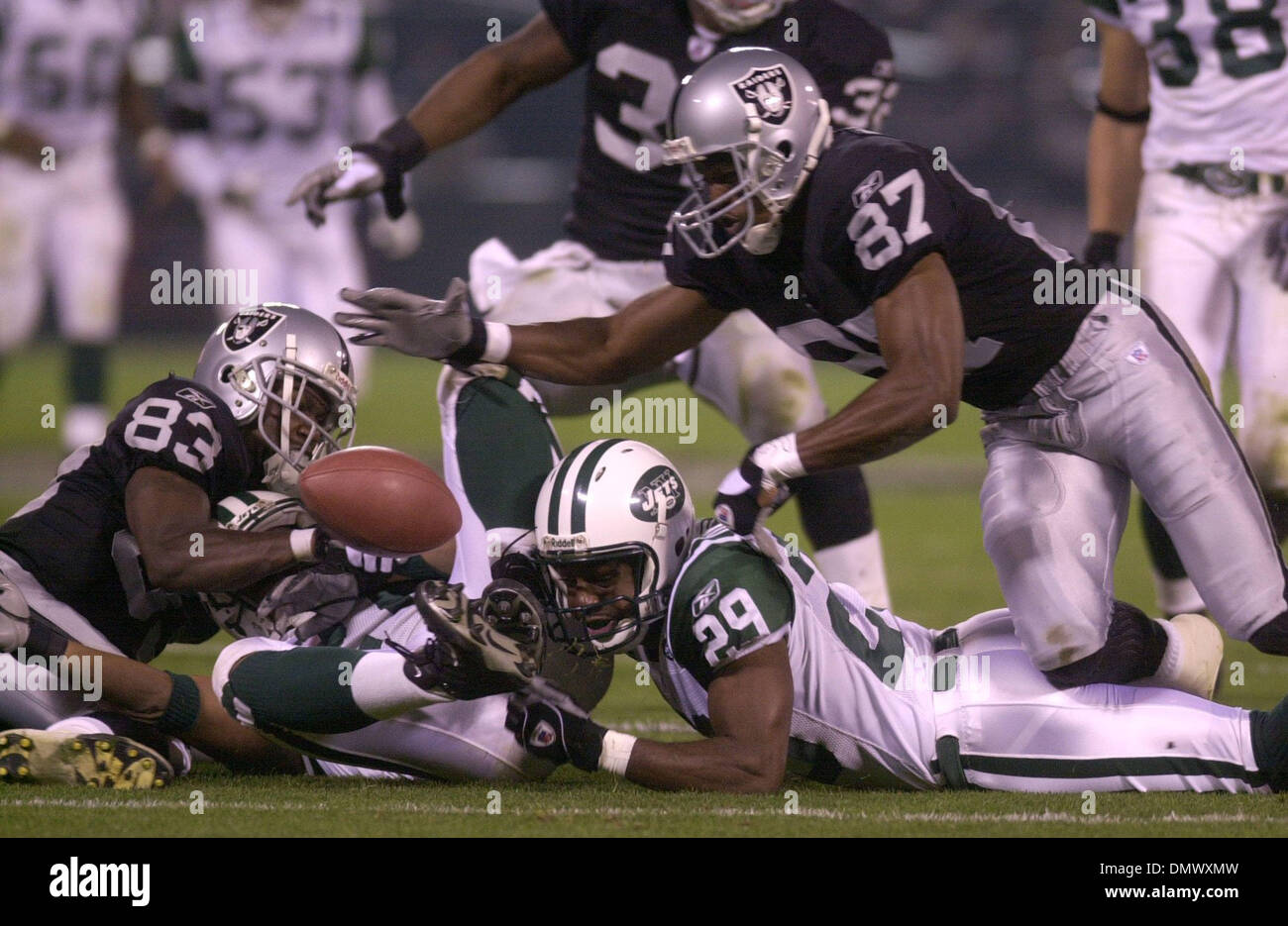 Dec 02, 2002; Oakland, CA, USA; Oakland Raiders' Charles Woodson, tackles  #28 Curtis Martin of the New York Jets'in the 4th quarter of their game on  Monday, December 2, 2002 at Network