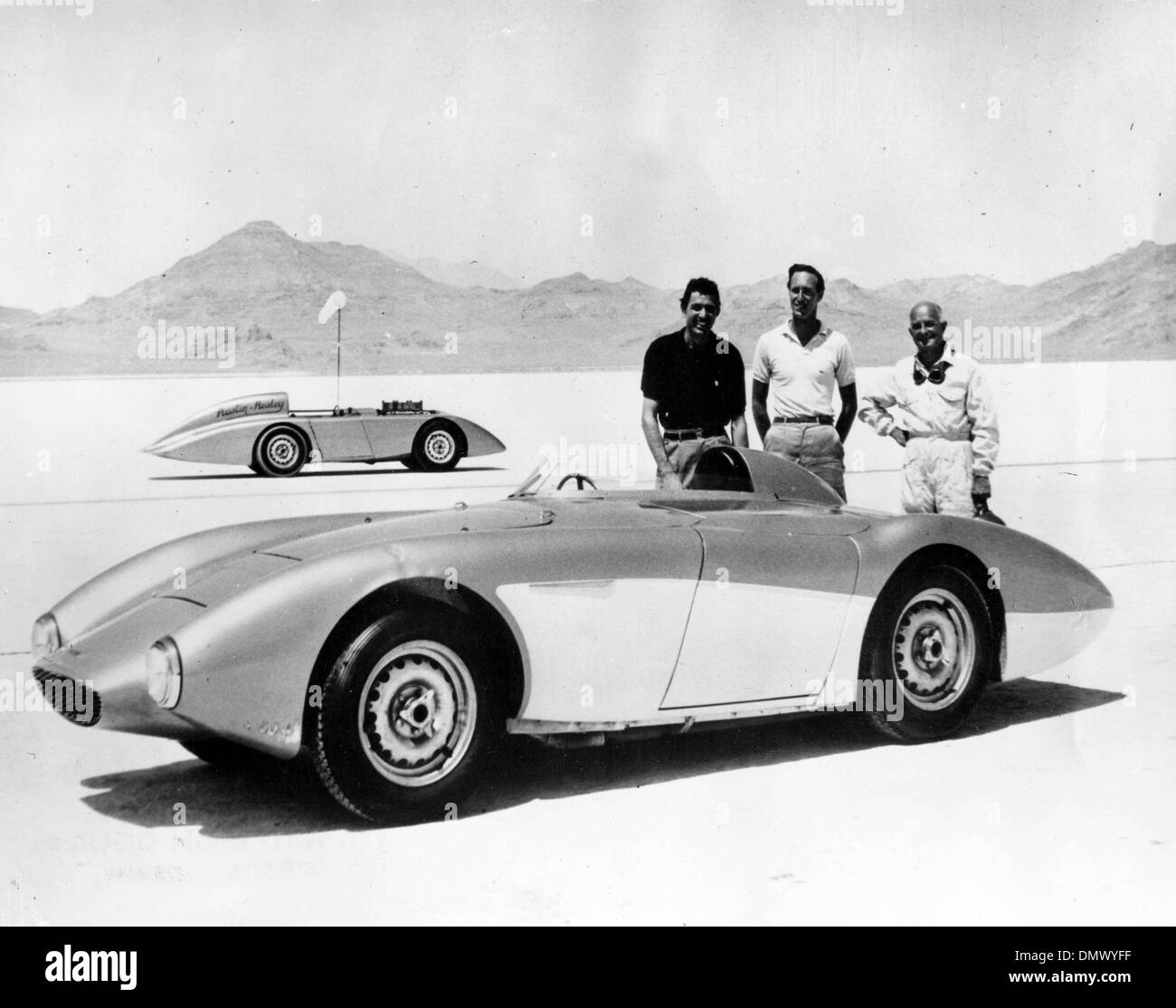 Aug. 17, 1956 - Bonneville, UT, USA - CAROLL SHELBY of Dallas, ROY JACKSON-MOORE of Los Angeles and Mr. DONALD HEALEY, with the car after setting the new records at the Bonneville Salt Flats in Utah, U.S.A.. The car in the background is another Austin Healey in which further record attempts may be made at Bonneville.  (Credit Image: © KEYSTONE Pictures USA/ZUMAPRESS.com) Stock Photo