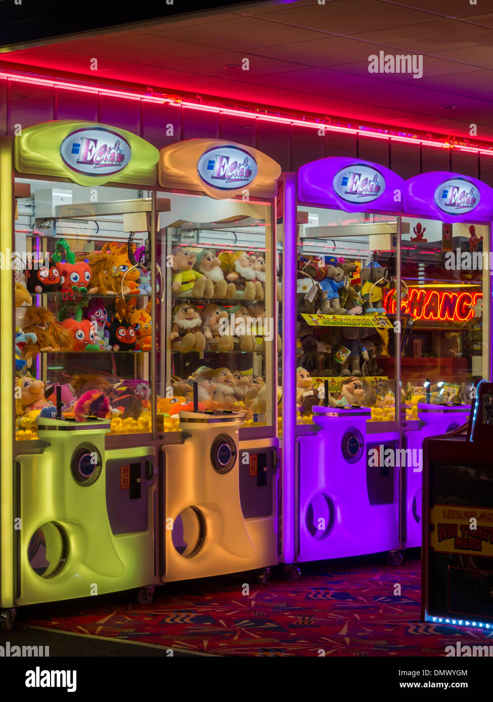 interior of amusement arcade with electro mechanical games illuminated at night with neon lights